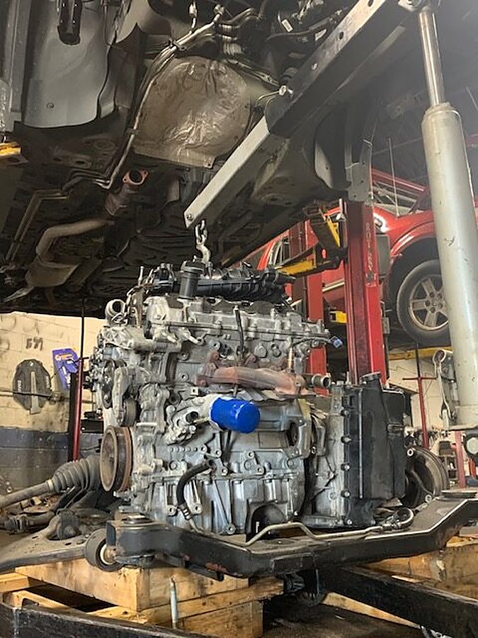 Engine assembly suspended in the NorthSide Garage workshop